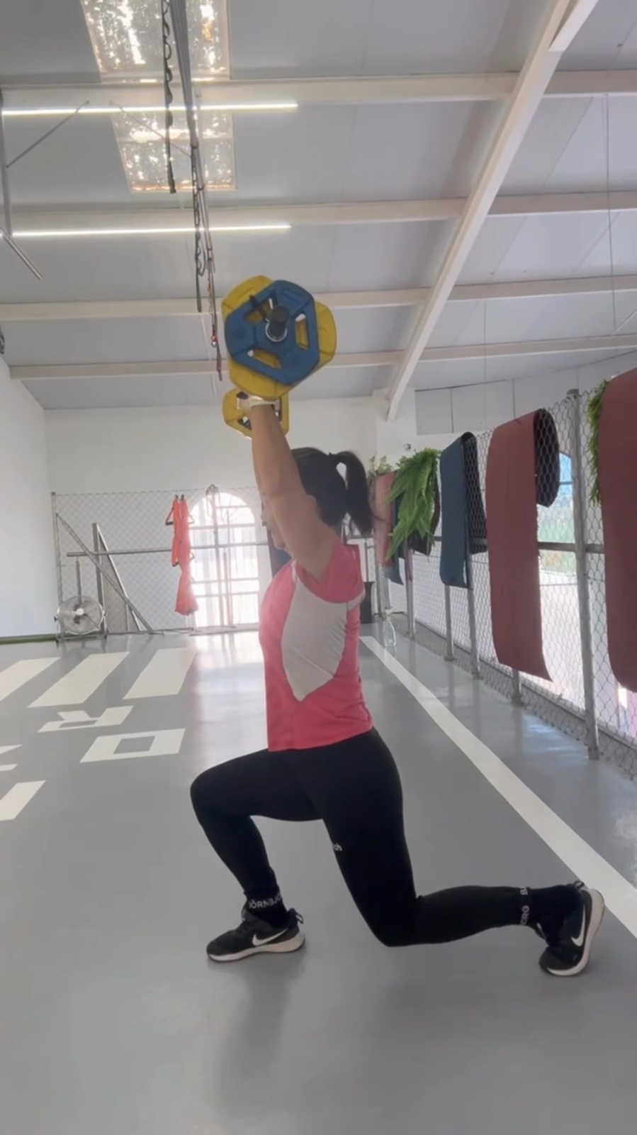 Woman doing a dumbbell lunge in the Pontewapa studio